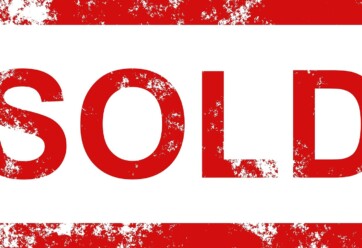 SOLD sign in red