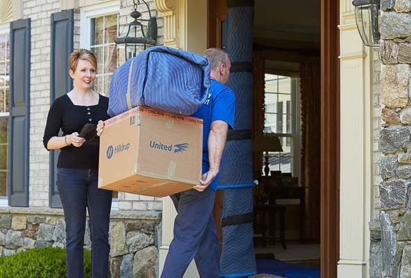 Mover bringing items into a home