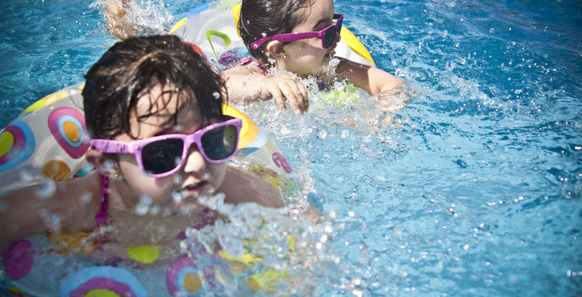 Children swimming with sunglasses on