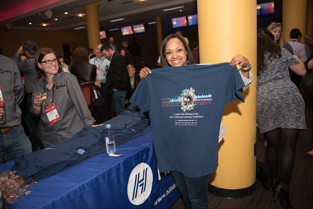 Woman holding up a t-shirt