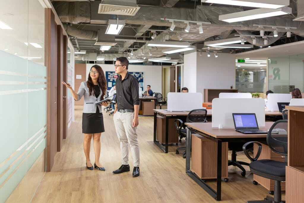 A corporate environment showing two people in the middle of a tour or walkthrough.
