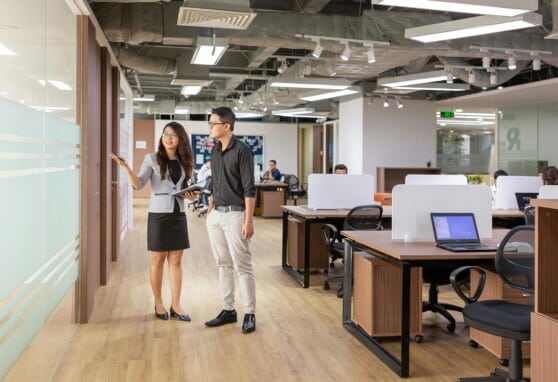 A corporate environment showing two people in the middle of a tour or walkthrough.