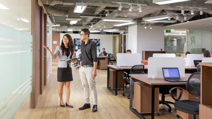 A corporate environment showing two people in the middle of a tour or walkthrough.