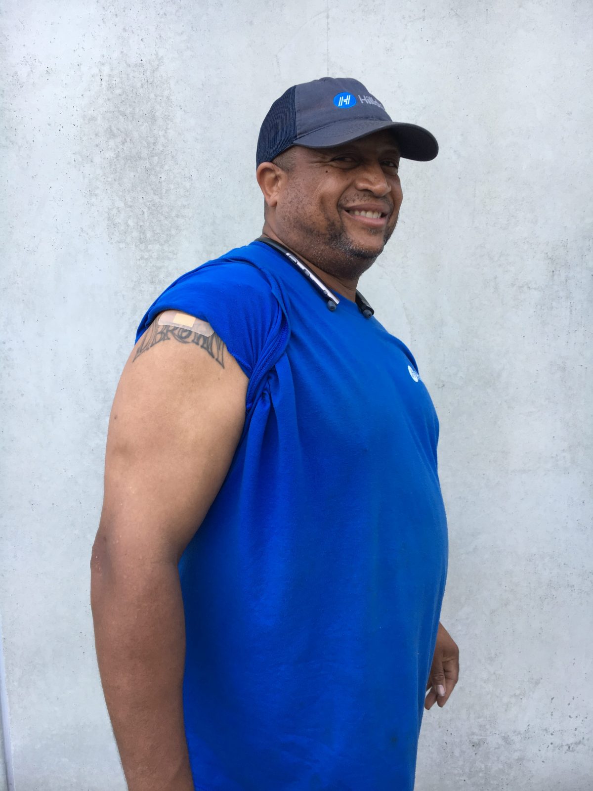 Employee displaying flu shot bandaid