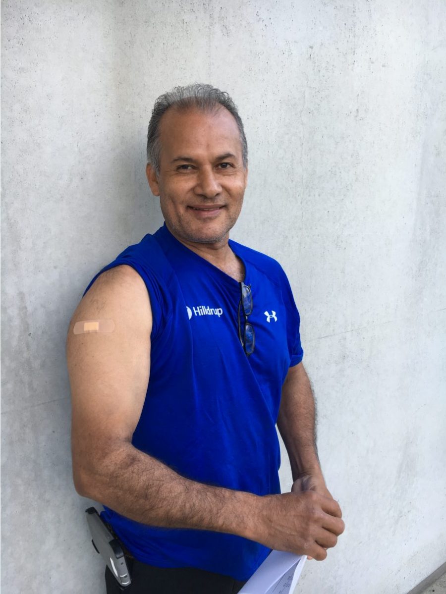 Employee displaying flu shot bandaid