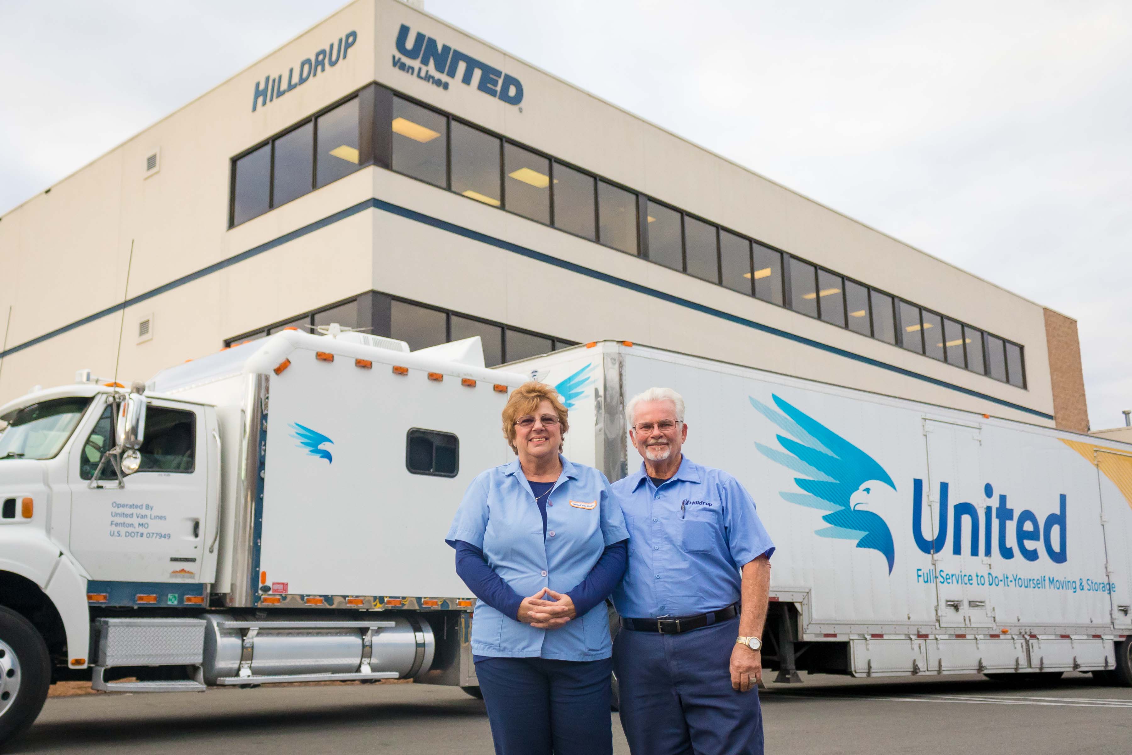 Joe and Sue Dean riding in Hilldrup truck