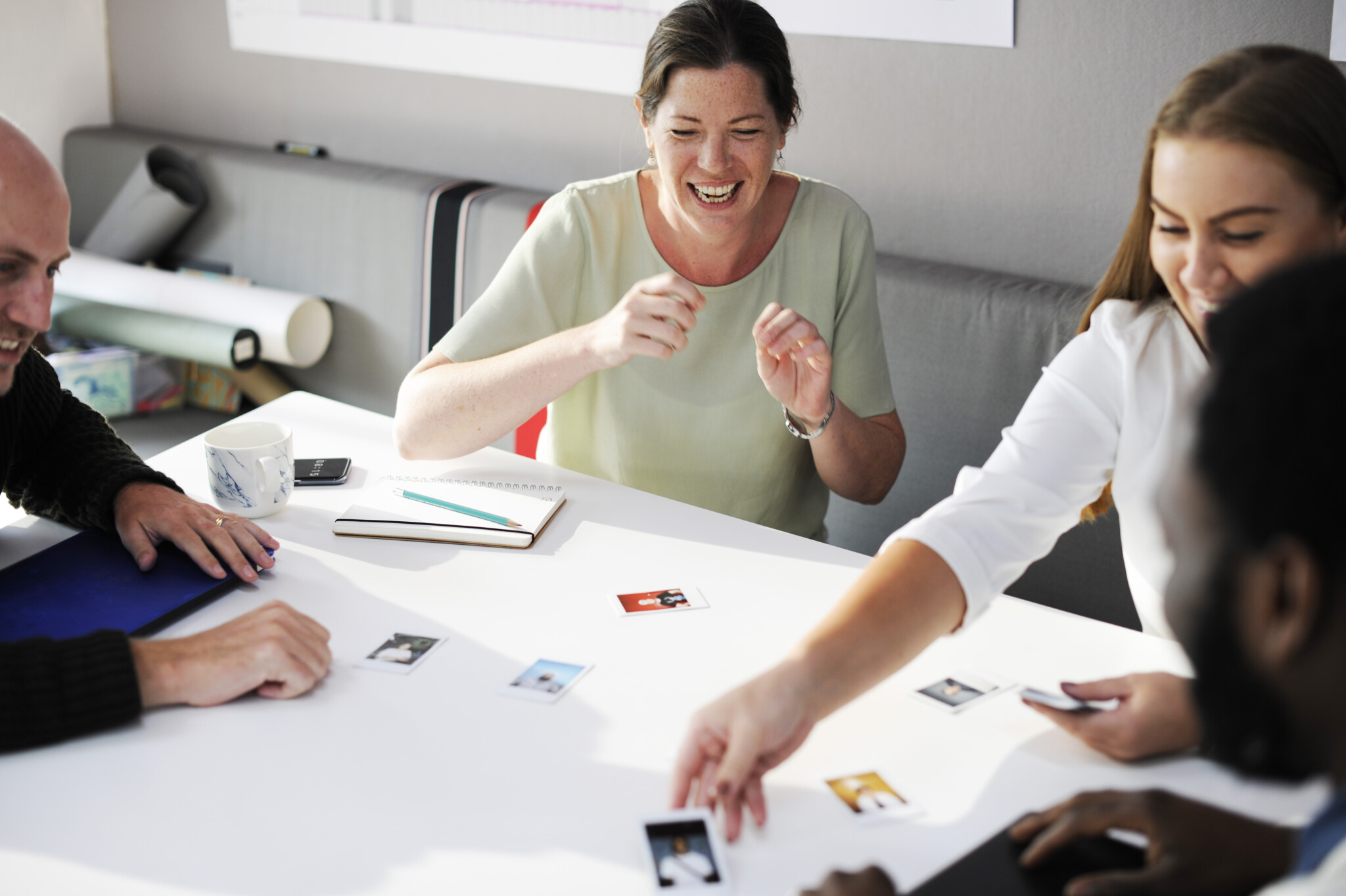 Employees working on putting photos together on a table