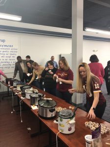 Employees line up to try samples of chili