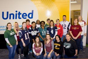Employees sport their favorite team's jerseys
