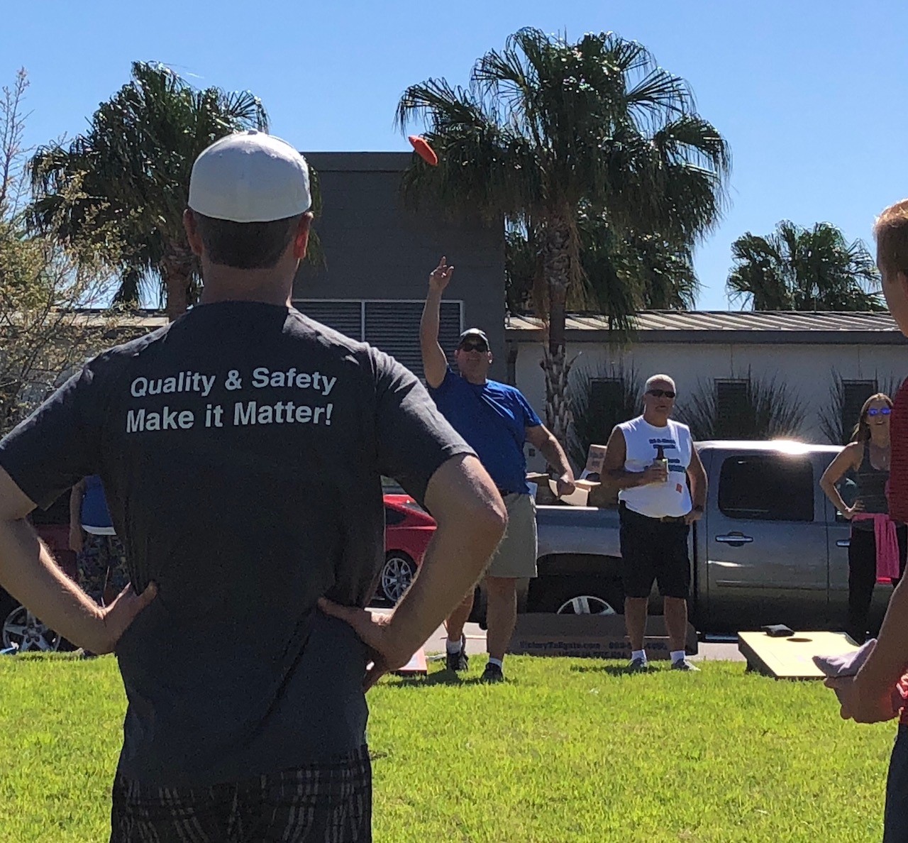 Hilldrup employees with Hilldrup cornhole board