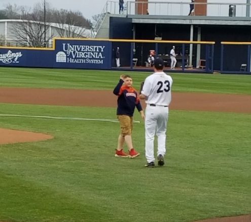 Boy highfives baseball player at UVA game