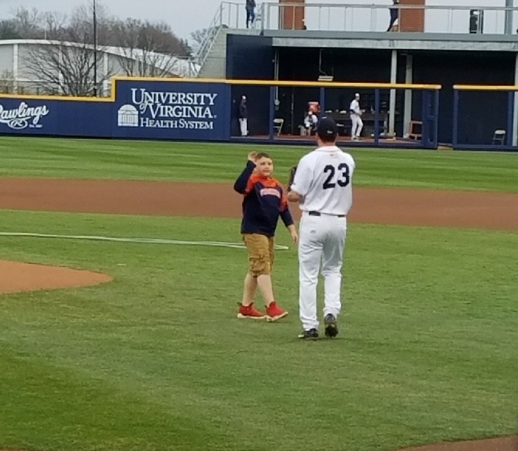 Boy highfives baseball player at UVA game