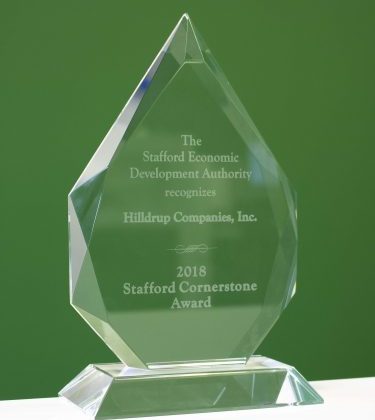 2018 Stafford Economic Development Authority Cornerstone Award in front of a green wall