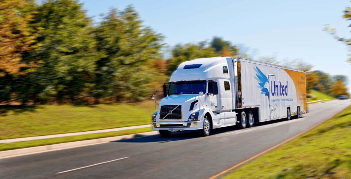 Hilldrup moving truck in motion on a backroad