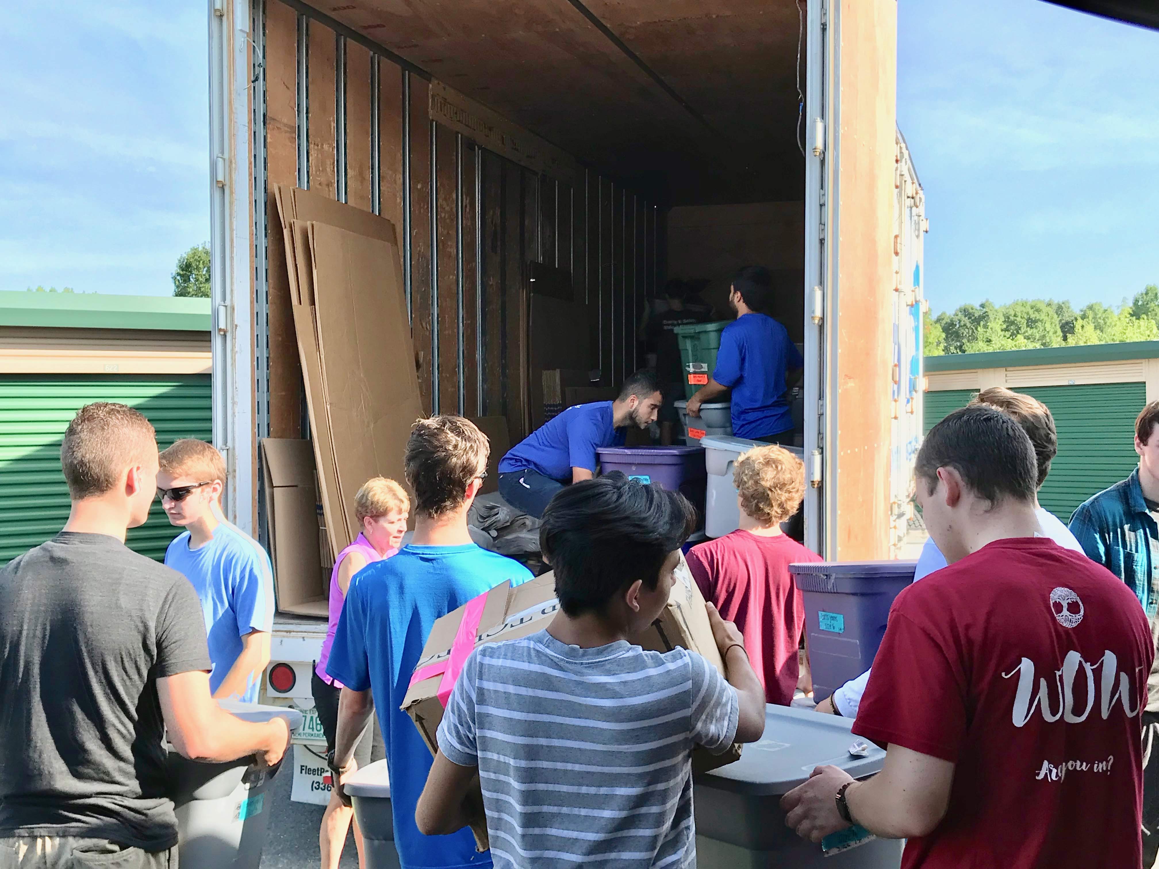 Young students load bins into Hilldrup truck