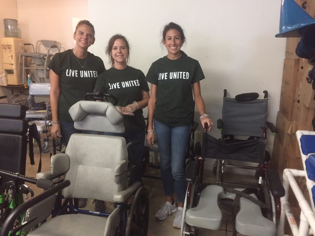 Hilldrup employees help clean and organize items for a retirement community