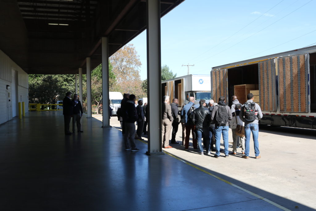 State Department visitors listen to a tour about our containers and warehousing