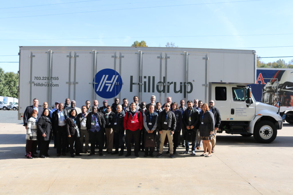 U.S. State Department visitors photographed next to Hilldrup truck