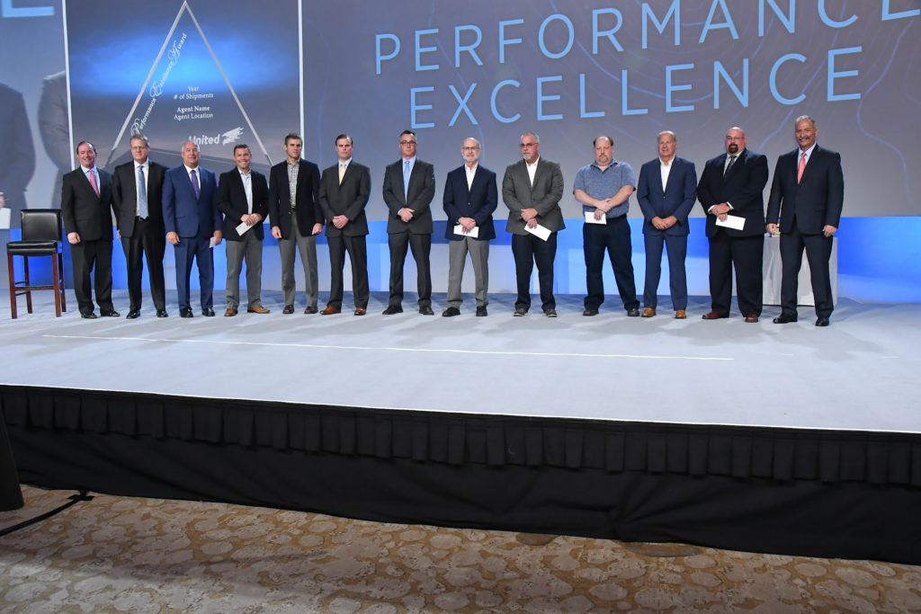 Performance Excellence Award Winners on stage at UniGroup event