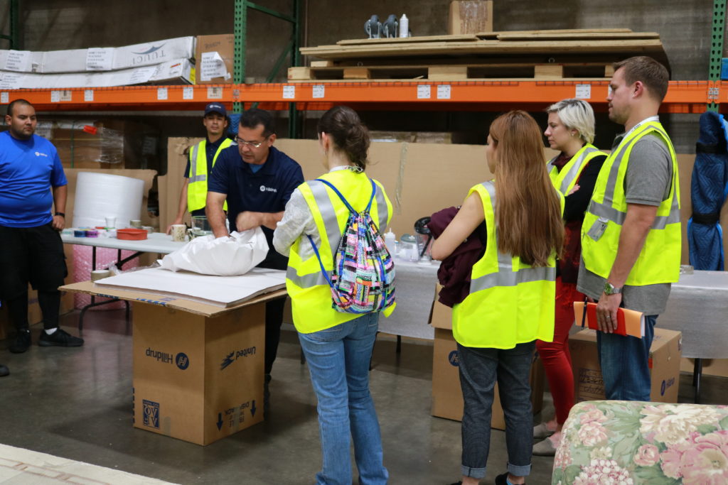 Students watch a packing demonstration