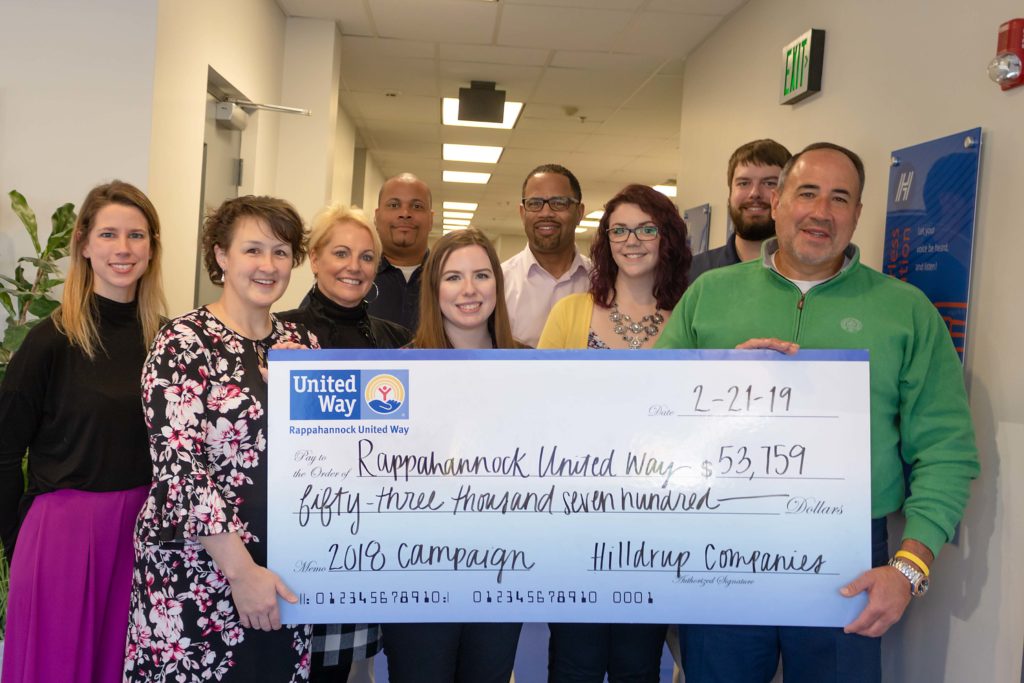 Charles W McDaniel and Hilldrup leaders posing with check of $53,000 for Rappahannock United Way