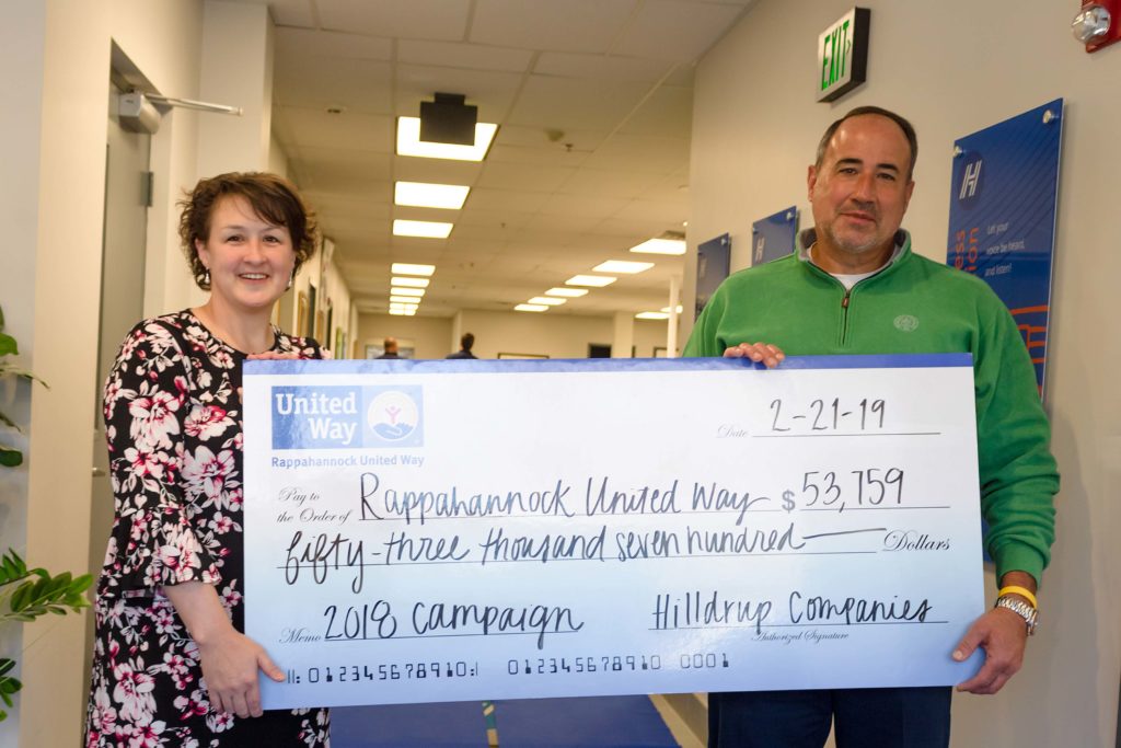 Janel Donohue and Charles W. McDaniel posing with check representing