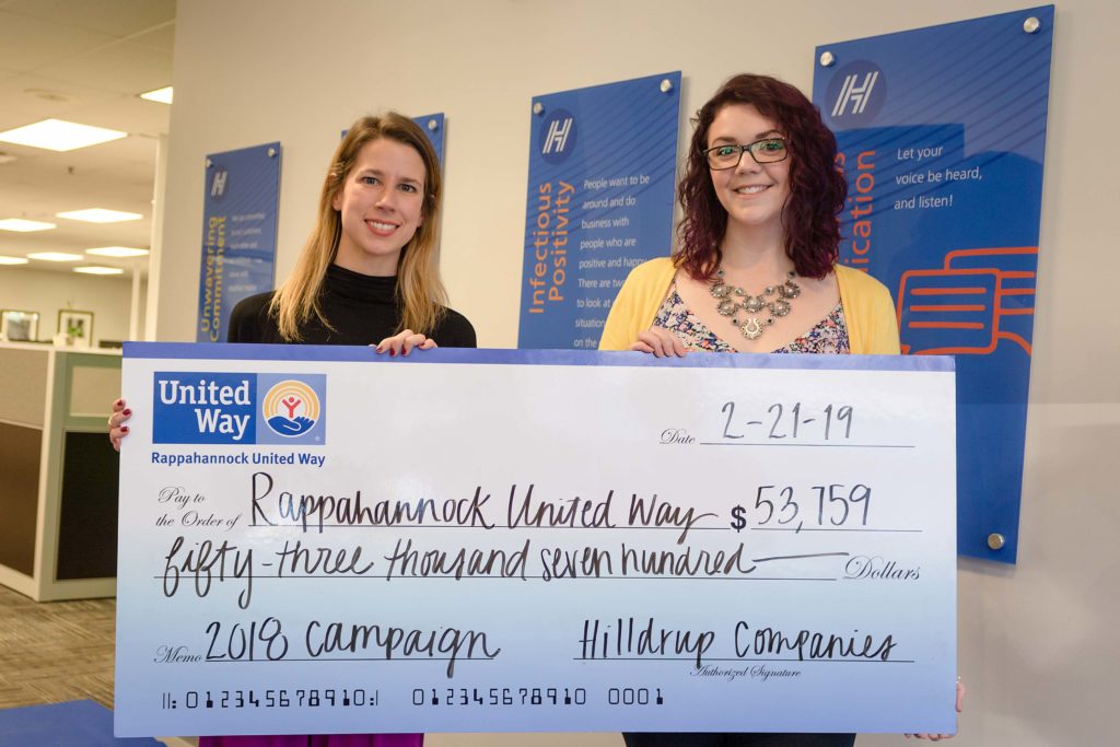 Grace Draper and Amanda Strawn posing with check of $53,000 for Rappahannock United Way