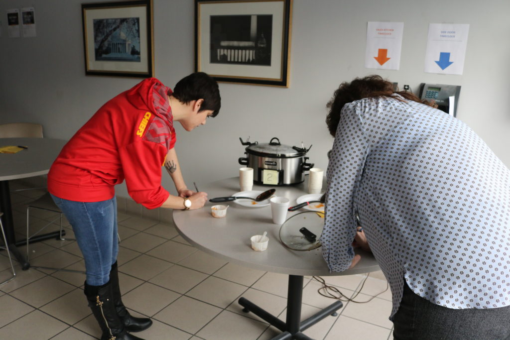 Employees vote for their favorite chili that they sampled