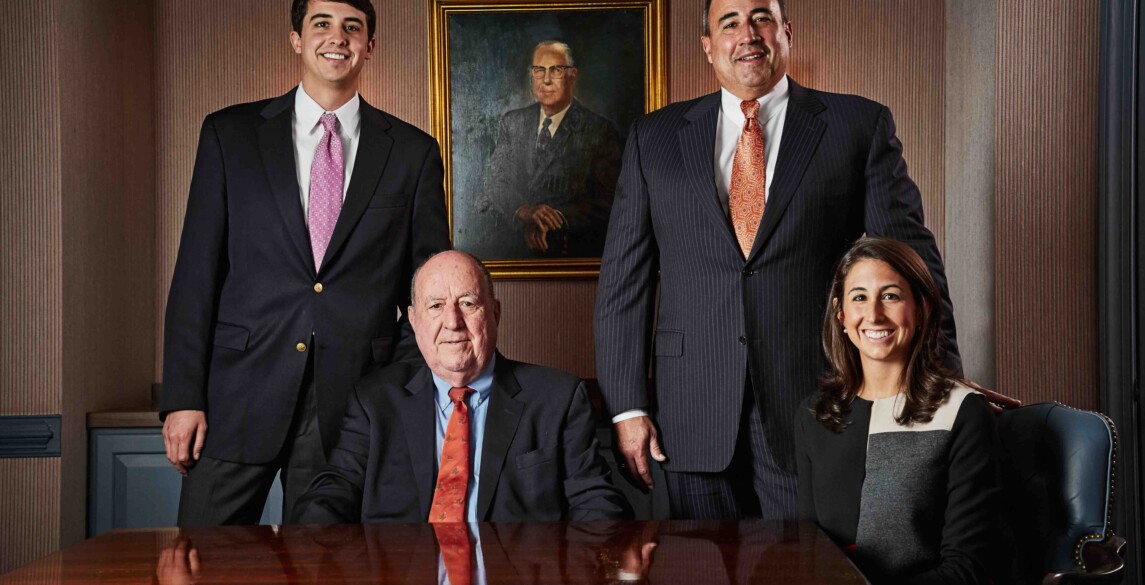 Charlie, Charles G., Charles W., and Jordan McDaniel posing in a conference room