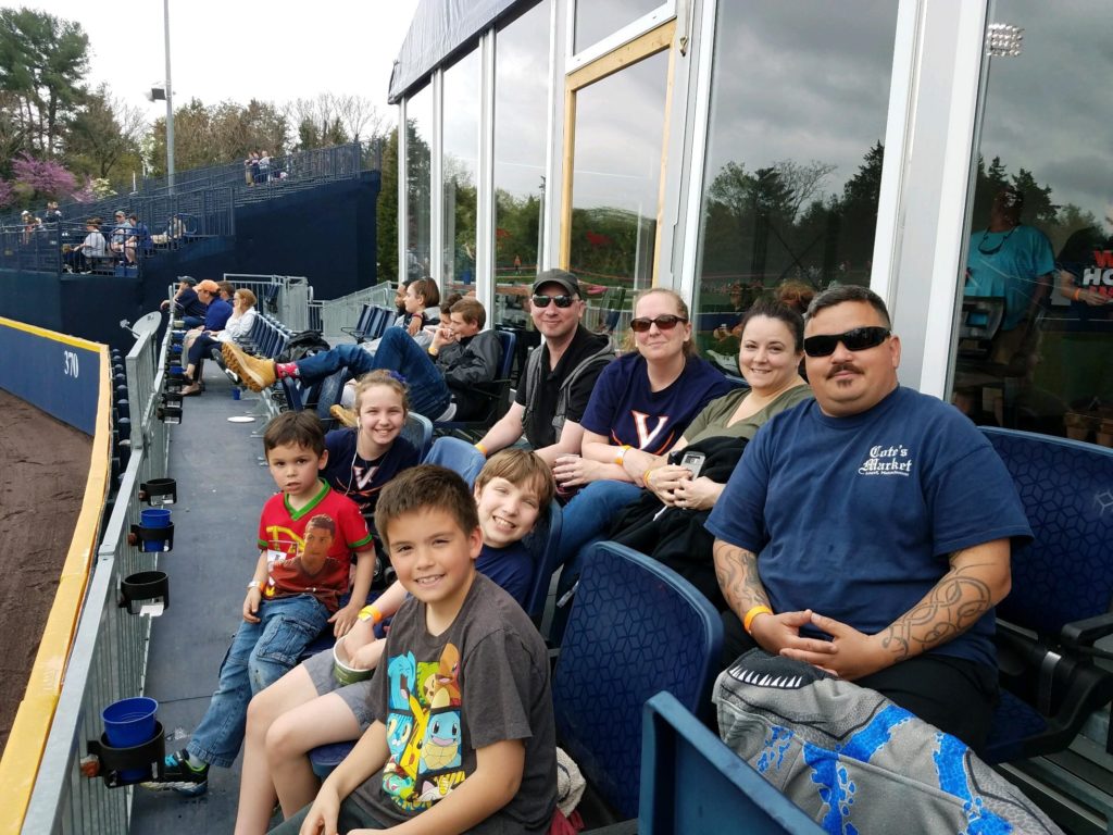 Group photo of Hilldrup employees and their kids in the club seats at UVA versus Miami baseball game