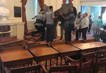 Hilldrup movers carefully standing up the speakers chair