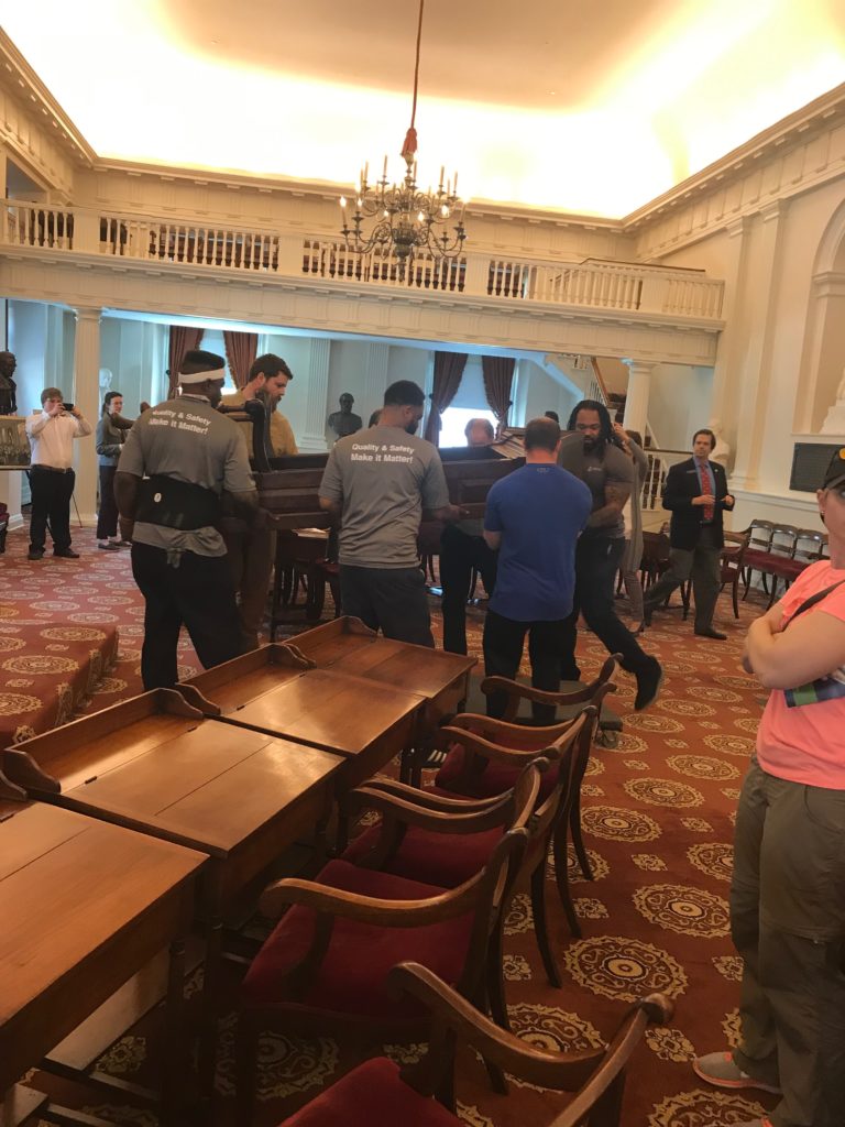 Hilldrup movers carefully moving 300 year old speakers chair into the Old House Chamber at the state capitol in Richmond