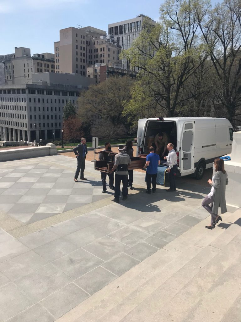 Hilldrup movers loading a 300 year old chair into a moving van