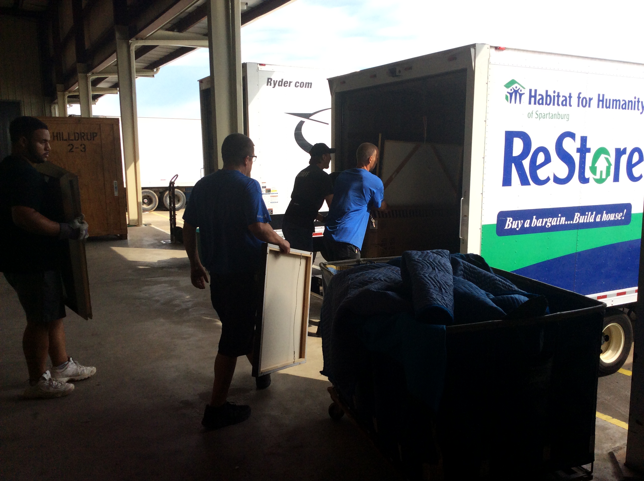 Hilldrup movers loading boxes into a moving truck