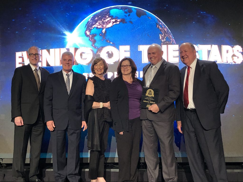 Charles G. McDaniel and other members of the leadership team receiving award at the AMSA's 100th Annual Education Conference and Expo from Johnny Abbott