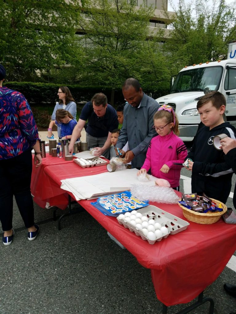 Hilldrup employees and their kids creating safety net for their eggs for the egg drop