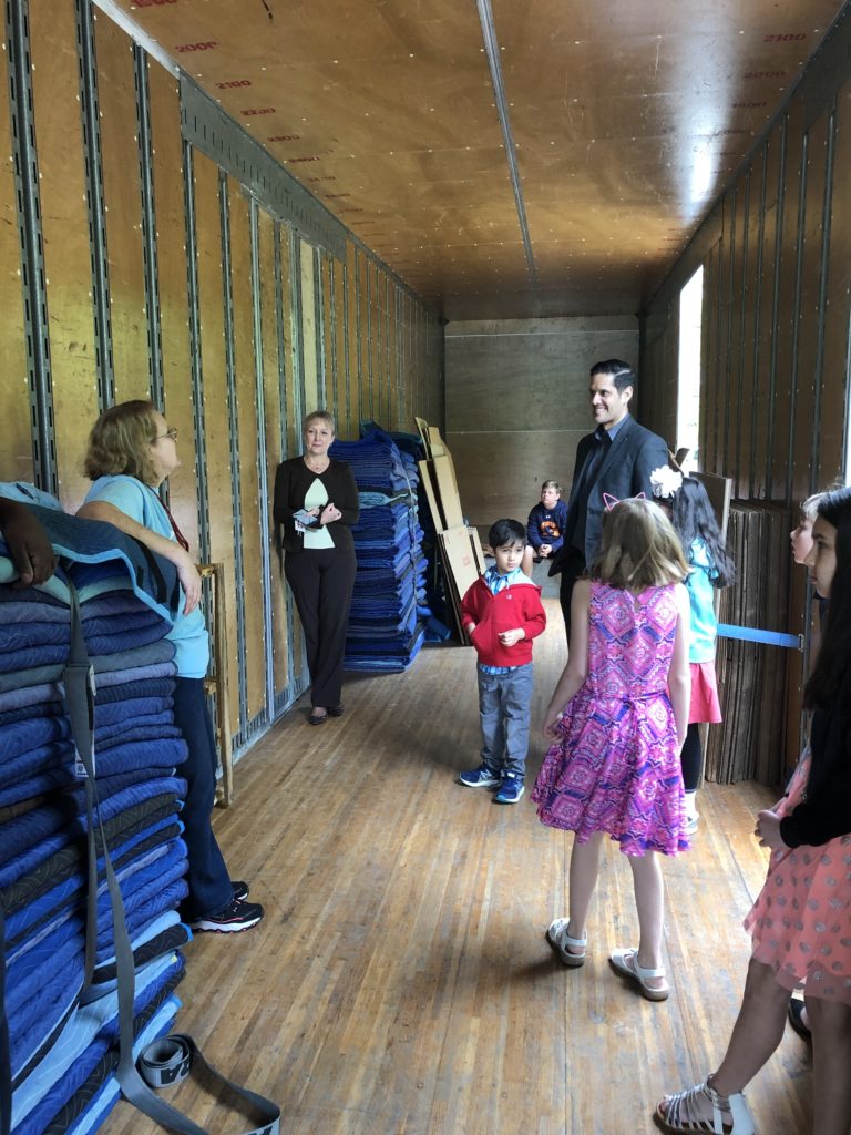 Hilldrup employees showing their kids the inside of a moving truck