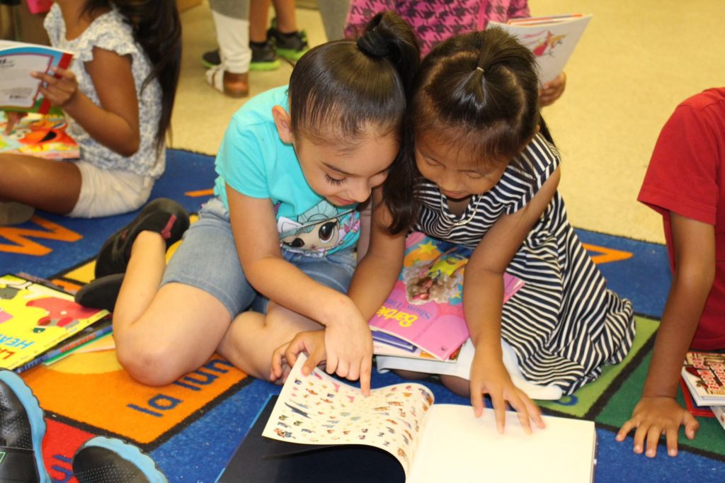 Two little girls reading