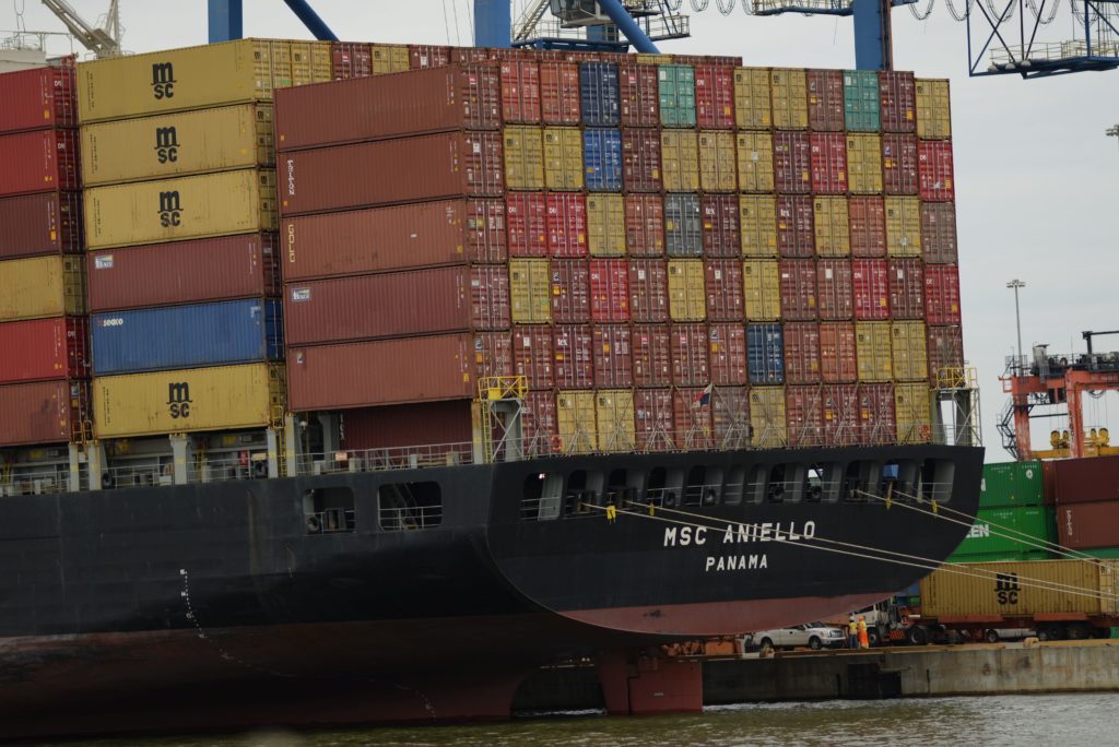 Stack of hundreds of shipping containers loaded onto cargo ship in Baltimore