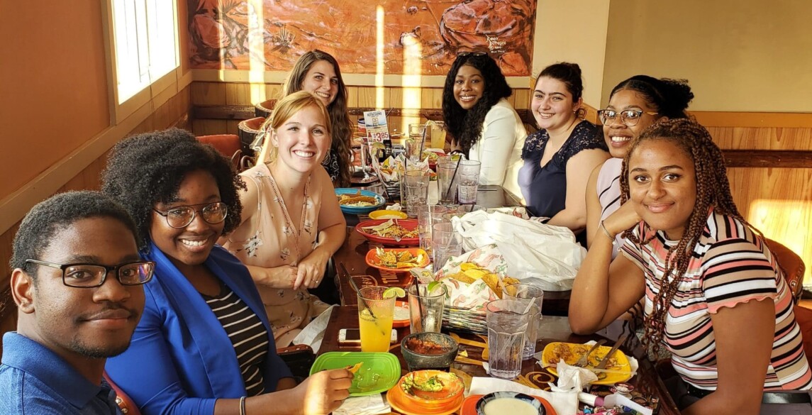 Hilldrup interns enjoy dinner at a restaurant together.