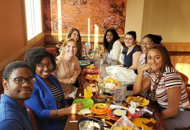 Hilldrup interns enjoy dinner at a restaurant together.
