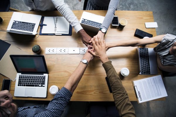 A team puts their hands in to celebrate teamwork