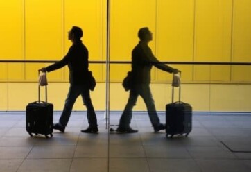 Two travelers walk in an airport