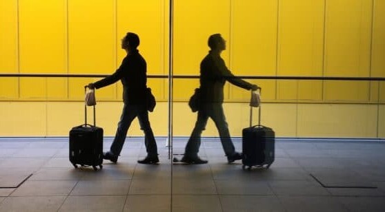 Two travelers walk in an airport