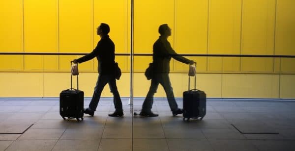 Two travelers walk in an airport