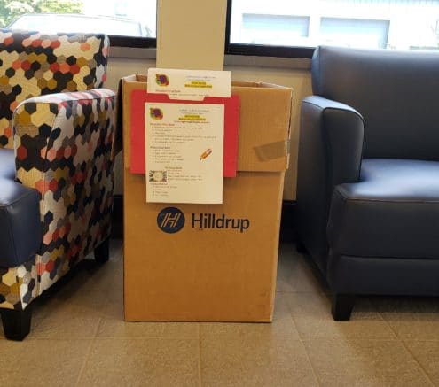 A Hilldrup box that holds donations for a school drive.