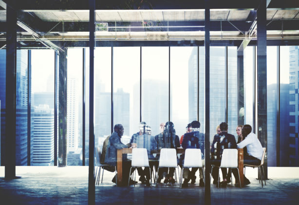 Employees at a meeting in a conference room