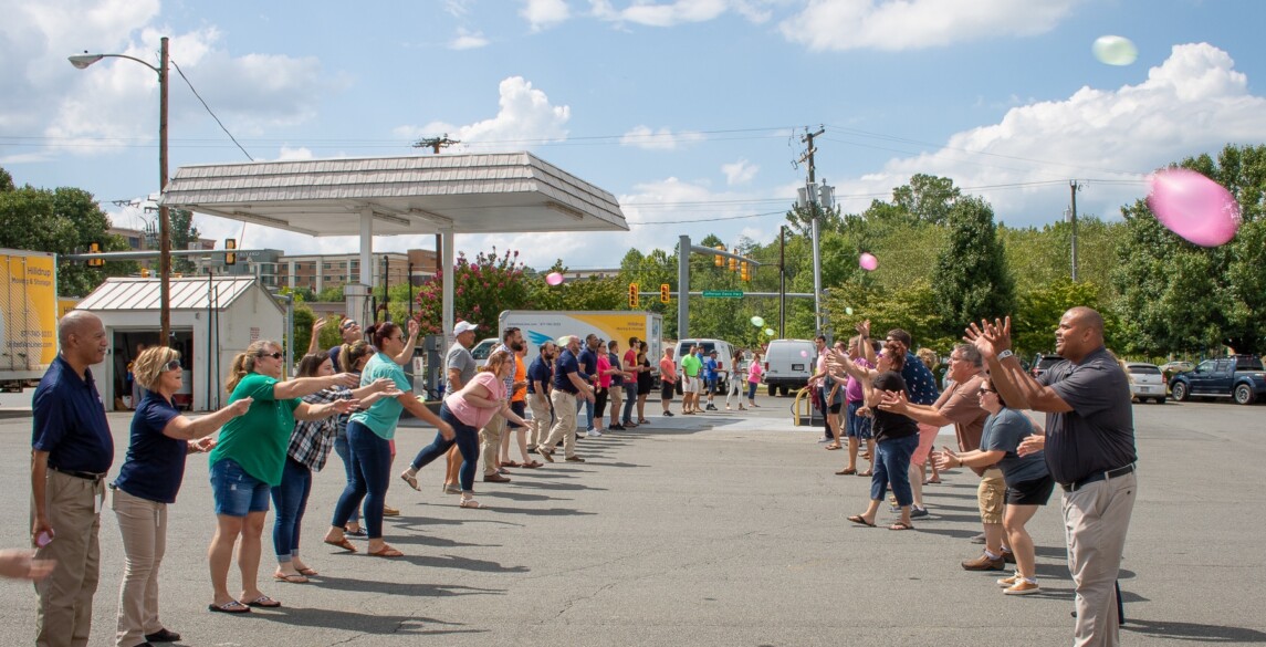 Hilldrup employees participating in a waterballoon toss.