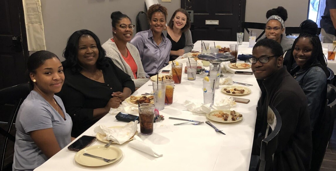 A table of Hilldrup interns enjoying dinner together