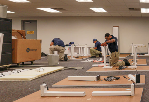 Hilldrup Commercial team members putting a cubicle together